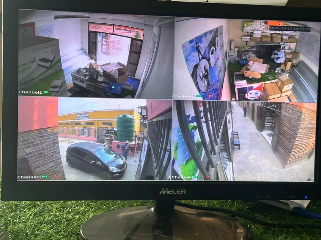 Four-camera business surveillance view displayed on a local monitor