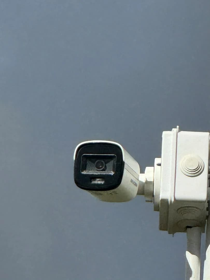 Close view of an outdoor bullet camera fixed to a pole junction box