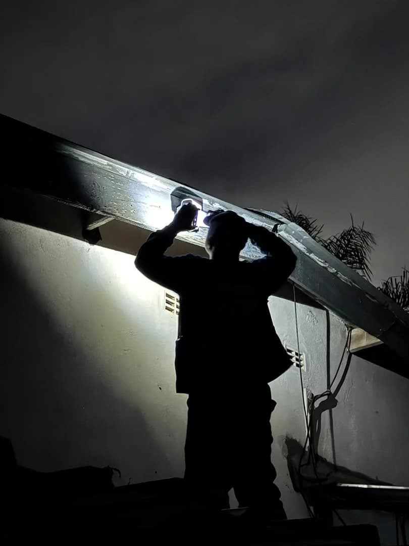 Wikilax Tech Solutions technician completing wireless camera installation work at night